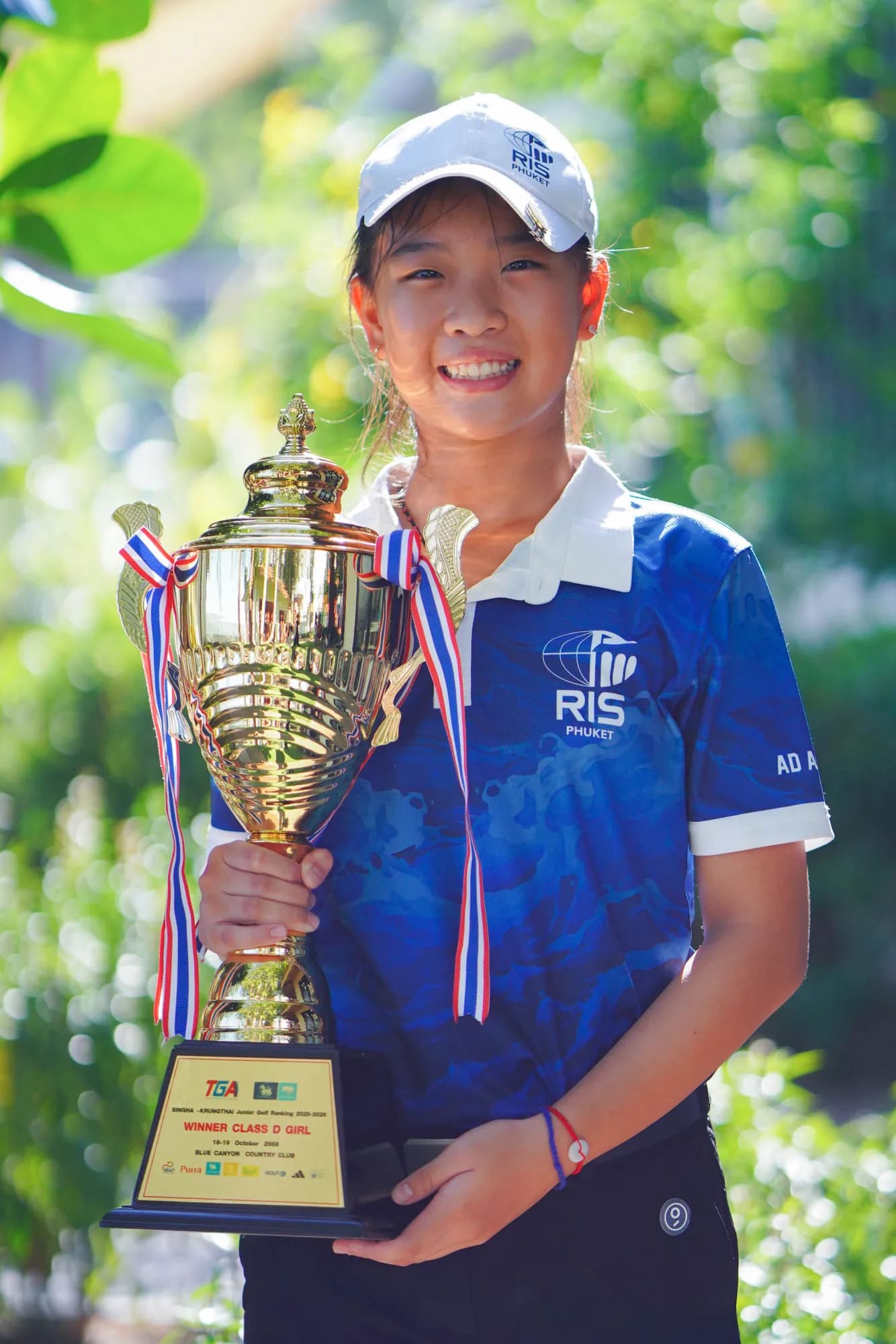 Student athlete with championship trophy
