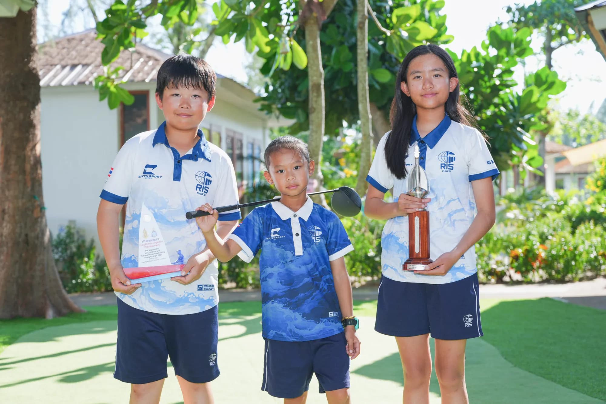 Student athletes with competition trophies